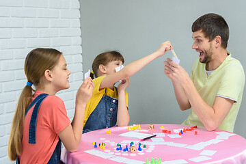 Image showing Children draw dad\'s card in a fun board game