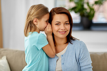 Image showing daughter whispering secret to mother at home