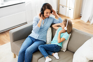 Image showing mother and daughter in headphones listen to music