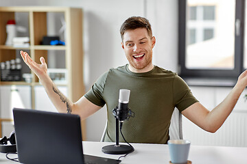 Image showing man with laptop and microphone at home office