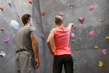 Image showing man and woman exercising at indoor climbing gym