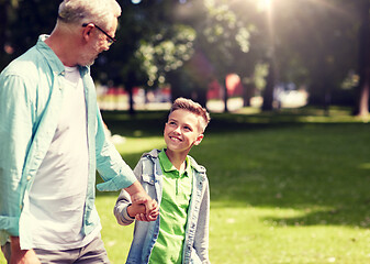 Image showing grandfather and grandson walking at summer park