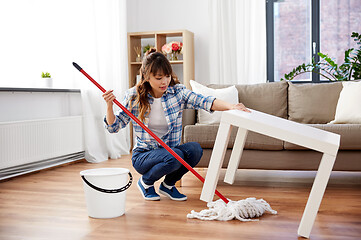 Image showing happy asian woman with mop cleaning floor at home