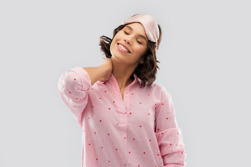 Image showing happy young woman in pajama and eye sleeping mask