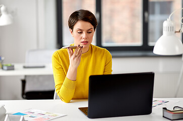 Image showing designer recording voice by smartphone at office