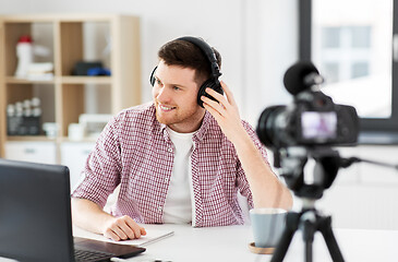 Image showing male blogger with headphones videoblogging