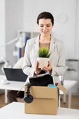 Image showing happy businesswoman with personal stuff at office