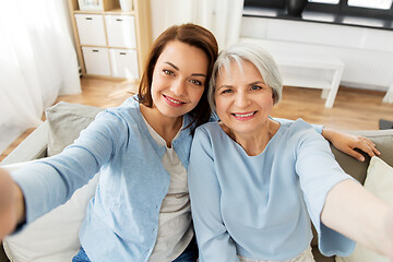 Image showing senior mother and adult daughter taking selfie