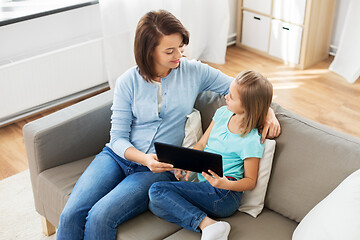 Image showing happy mother and daughter with tablet pc at home