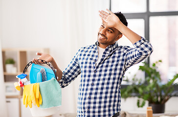 Image showing tired man with bucket of cleaning stuff at home