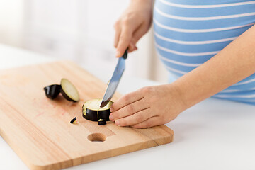 Image showing close up of pregnant woman cooking food at home