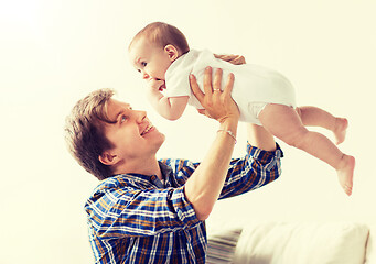 Image showing happy young father playing with baby at home