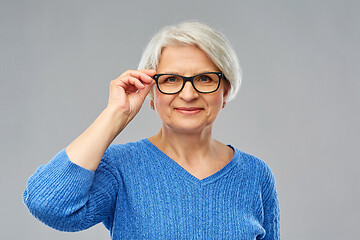 Image showing portrait of senior woman in glasses over grey