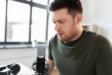 Image showing male audio blogger with microphone broadcasting