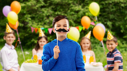 Image showing happy boy with black moustaches at birthday party