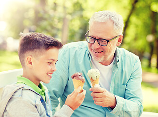 Image showing old man and boy eating ice cream at summer park