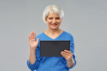 Image showing senior woman having video call on tablet computer