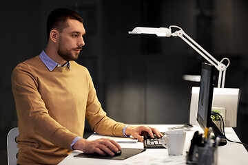 Image showing man with computer working late at night office