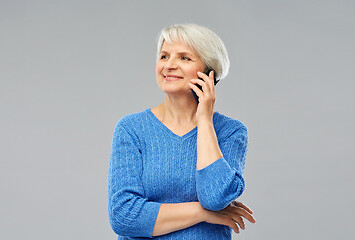 Image showing smiling senior woman calling on smartphone