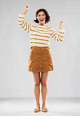 Image showing young woman in striped pullover, skirt and shoes