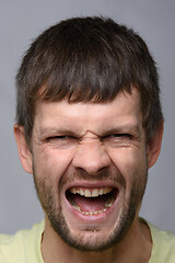 Image showing Portrait of a man of European appearance, experiencing severe pain, close-up