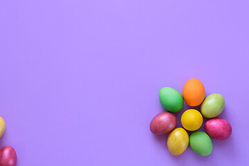 Image showing Easter eggs in the shape of a flower on a purple background, on the left there is a place for inscription