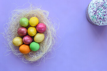 Image showing Easter eggs on a purple background, next to Easter cake