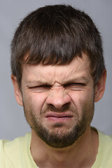 Image showing Close-up portrait of a man with an emotion of disgust, European appearance