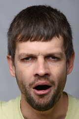 Image showing Closeup portrait of a tired yawning man of European appearance