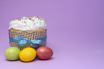 Image showing Easter cake and three eggs on a dark pink background