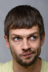 Image showing Close-up portrait of a pensive man twisting his mouth, European appearance