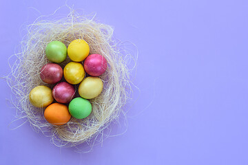 Image showing Easter eggs in a makeshift nest on a purple background