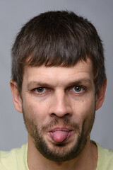 Image showing Portrait of a man of European appearance showing tongue, close-up