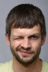 Image showing Close-up portrait of a man covering one eye, European appearance