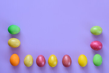 Image showing Easter eggs laid out around the perimeter on a purple background