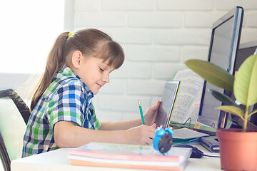 Image showing Girl attends school remotely through online video tutorial