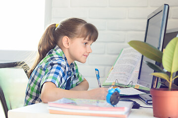 Image showing Girl watching a video lesson at home on distance learning