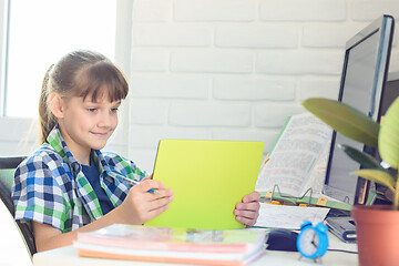 Image showing Girl watching video tutorials on a tablet while at home