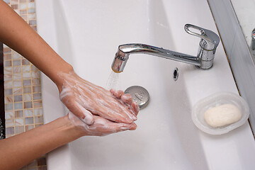 Image showing Female hands wash their hands thoroughly with soap