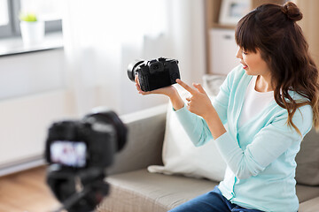 Image showing asian female blogger with camera recording video