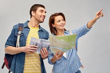 Image showing happy couple of tourists with city guide and map