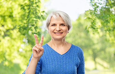 Image showing portrait of smiling senior woman showing peace