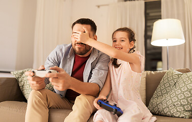 Image showing father and daughter playing video game at home
