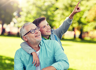 Image showing grandfather and boy pointing finger at summer park