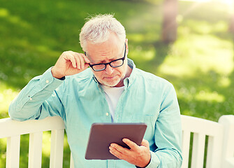 Image showing senior man with tablet pc at summer park