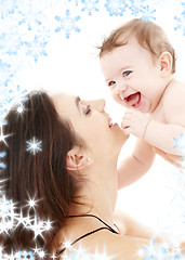 Image showing laughing blue-eyed baby playing with mom