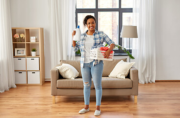 Image showing woman with basket and laundry detergent at home