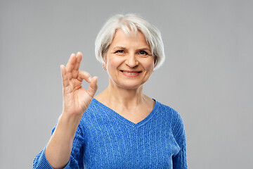 Image showing portrait of smiling senior woman making ok gesture