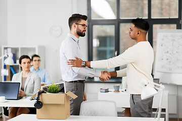 Image showing colleague seeing off sad fired male office worker