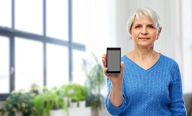 Image showing senior woman showing smartphone at home